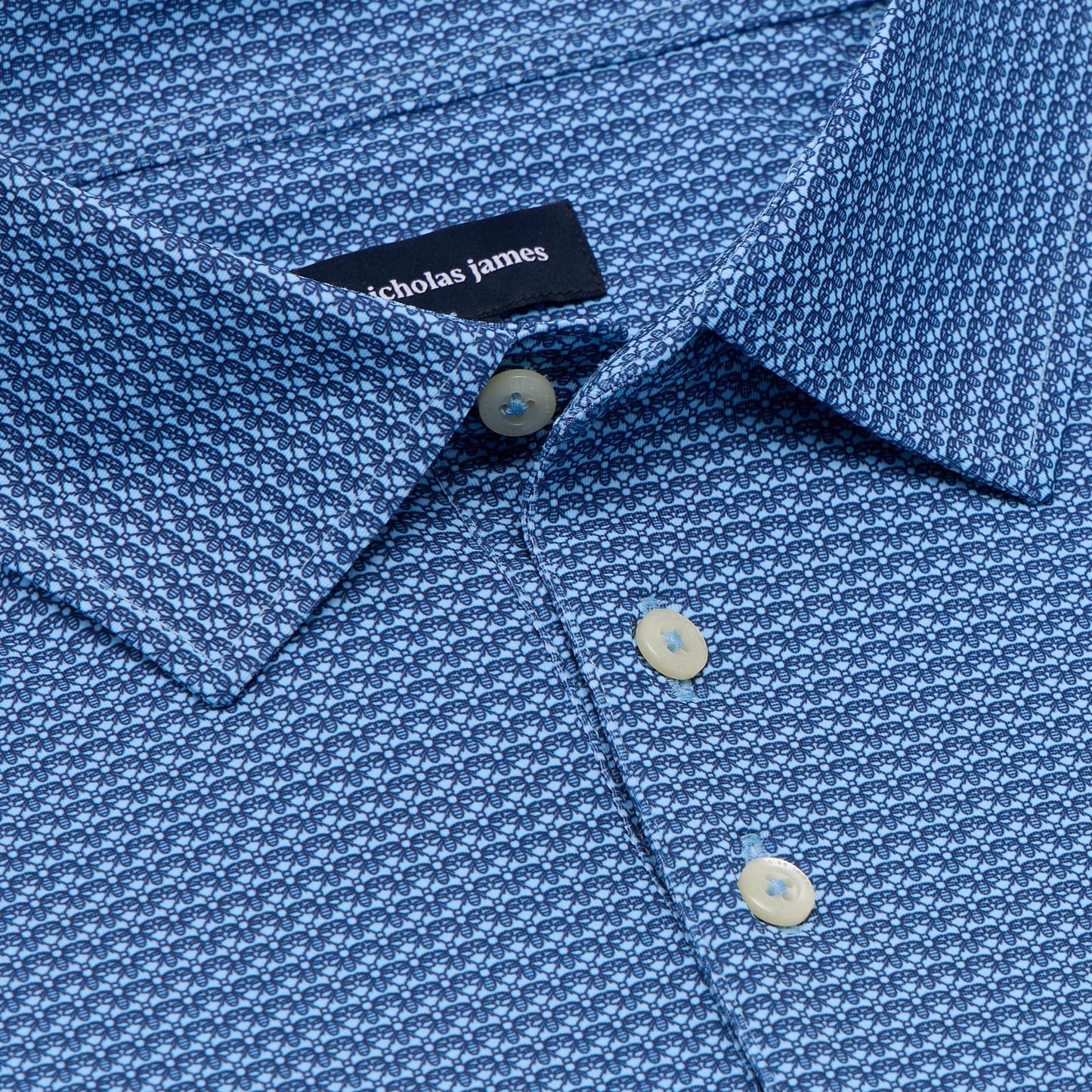 Close-up of a blue patterned shirt with a Nicholas James label.
