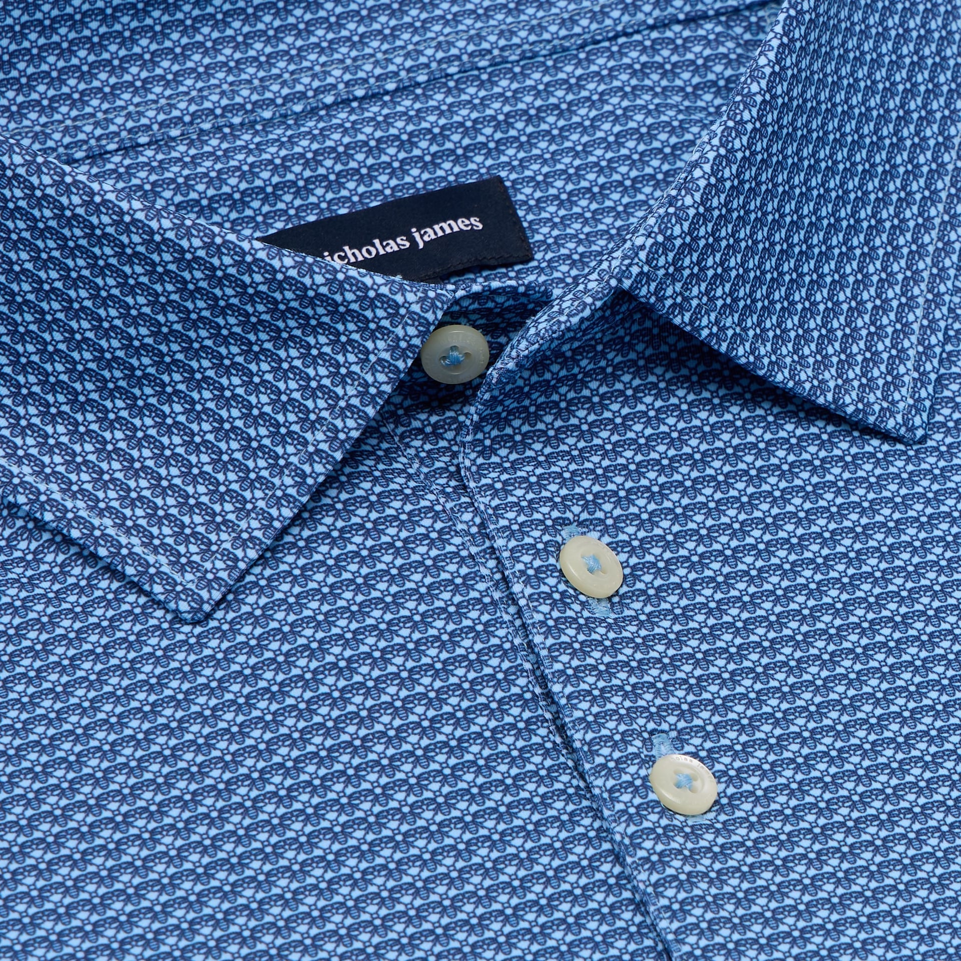 Close-up of a blue patterned shirt with a Nicholas James label.