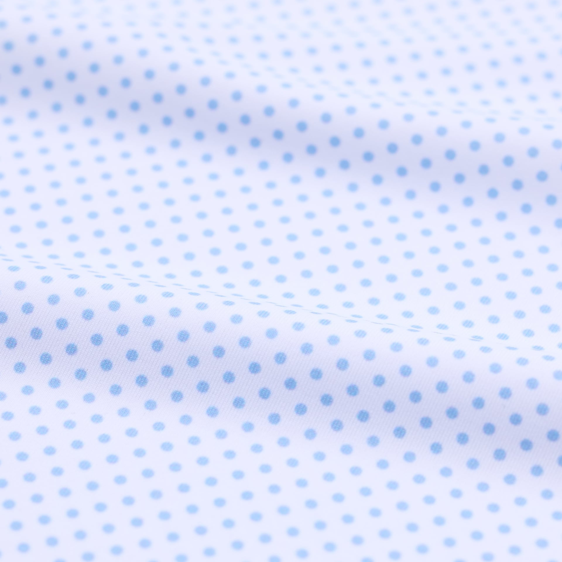 White fabric with small blue polka dots