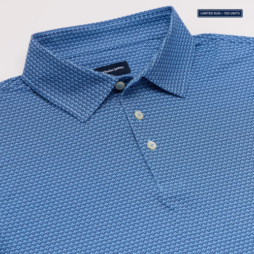 Blue bee patterned polo shirt with nicholas james label on a light gray background